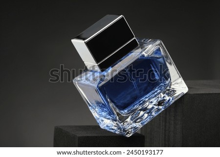 Luxury men`s perfume in bottle against grey background, closeup
