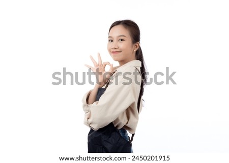 Portrait smiling young asian woman wearing apron showing ok sign with hand isolated white background, young asian woman making okay gesture, waitress or entrepreneur, small business or startup.