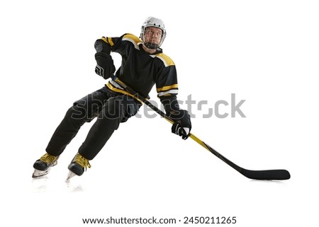 Dynamic image of competitive focused man, hockey player in motion during game, preparing for competition isolated on white background. Concept of professional sport, competition, game, tournament