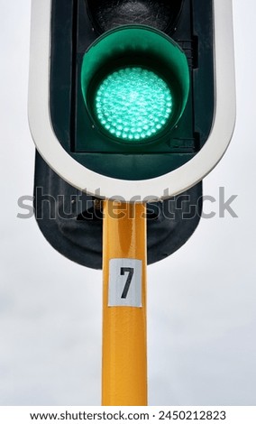 Green traffic light, city or outdoor sign for control, movement or rules for safety on urban street. Go symbol, background or icon for road, sidewalk or signal for public or transportation in town