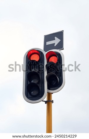 Traffic light, stop and street rules in city for transport direction or delay, commute or safety. Sign, red and arrow with warning for vehicle driving or urban travel with caution, downtown or road