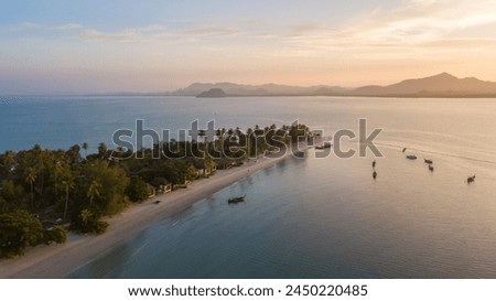 Aerial view of koh Mook with beautiful sky and sunrise, in Trang, Thailand. It is a small idyllic island in the Andaman Sea in the south of Thailand. Royalty-Free Stock Photo #2450220485