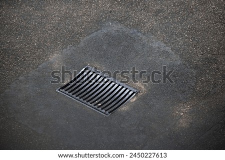 GRID IN TARMAC SITUATED OVER AN UNDERGROUND STORMWATER DRAIN