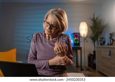 Middle aged woman suffering from pain in hands, closeup. Woman massaging her arthritic hand and wrist. Painful Wrist. Elderly female patient suffer from numbing pain in hand,numbness fingertip,arthrit