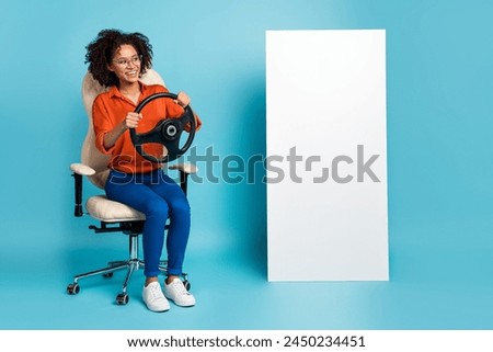 Photo of dreamy lady worker dressed orange shirt glasses riding auto gadget empty space isolated blue color background
