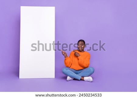 Full body photo of young girl sit floor indicate fingers empty space select suggest promoter isolated over violet color background