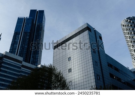 The dynamic skyline of a modern city featuring diverse architectural styles and designs, captured against a dusky sky. Royalty-Free Stock Photo #2450235781