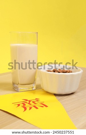 Vegetarian festival triangle flag with almond and Glass of soybean milk, Translation for Chinese and Thai letter is stand for symbol text of vegetarian festival or the meaning of refrain eating meat. 