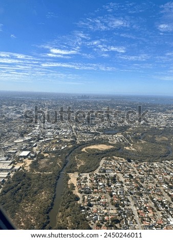 Aerial view of a river and city through airplane window