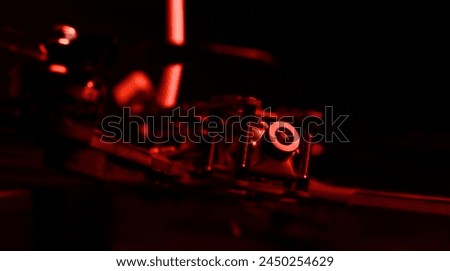 Cruise camera of fpv copter. Dron on a table in a red light. Royalty-Free Stock Photo #2450254629