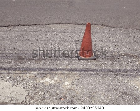 BATTFE Shabby 15 inch Orange Traffic Safety Cone and asphalt road background