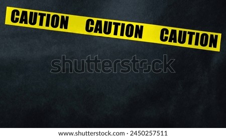 Caution Yellow Tape Strip On A Black Background