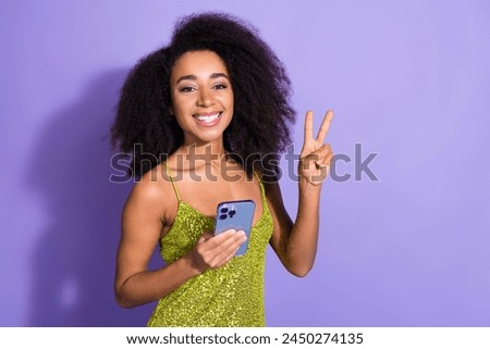Photo of cheerful cute woman blogger wear stylish green clothes v-sign isolated on purple color background
