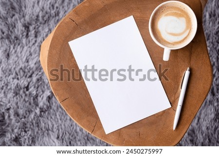 blank notepaper mockup on coffee table with cappuccino, pen and grey rug. Template notepaper