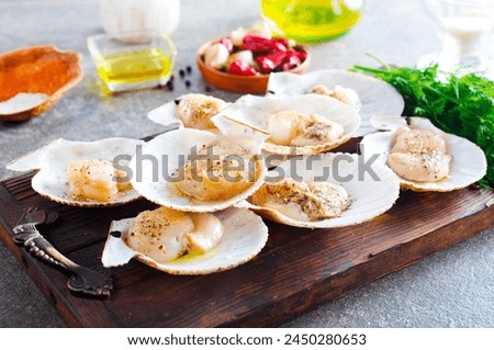 fresh appetizing scallop with shell served on board