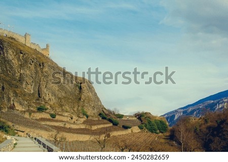 A fortress on a mountainside under a clear, blue sky in Switzerland, on a spring day. Traveling around Switzerland, Sjön.