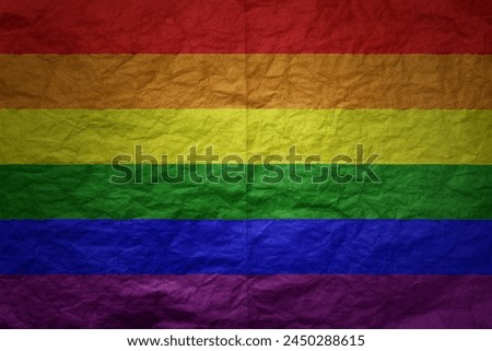 colorful big rainbow gay pride flag on a grunge old paper texture background