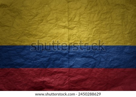 colorful big national flag of colombia on a grunge old paper texture background
