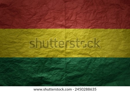colorful big national flag of bolivia on a grunge old paper texture background