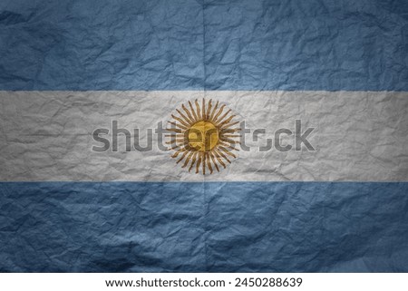 colorful big national flag of argentina on a grunge old paper texture background
