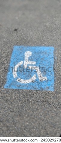 An asphalt parking sign and symbol for handicap parking only.