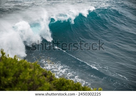 Blue Waves crashing on rocks with splashes