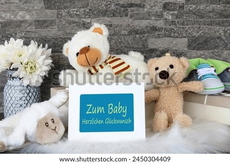 Congratulations for the baby: gifts and decorations for the birth of the child. German inscription translates as Congratulations on the baby.