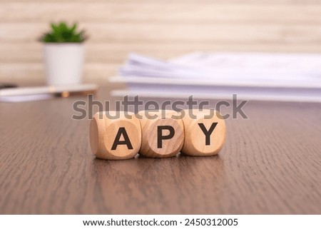 text APY on wooden cubes over blur background with copy space, Annual Percentage Yield concept