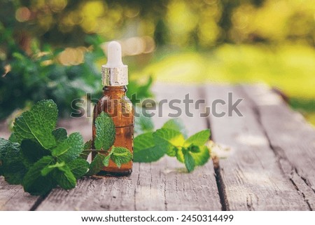 Peppermint essential oil in a bottle. selective focus. nature.