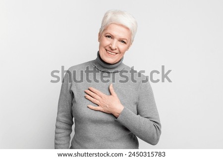 A cheerful senior, elderly European woman displays confidence with a bright smile, exemplifying s3niorlife positivity Royalty-Free Stock Photo #2450315783