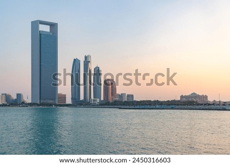 A picture of the Etihad Towers, the Abu Dhabi National Oil Company Headquarters and the Emirates Palace Mandarin Oriental Hotel at sunset.