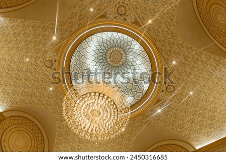 A picture of a chandelier in the ceiling of Qasr Al Watan.