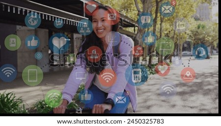 Image of social media icons and business data over biracial woman cycling. Global social media, business, connections and data processing concept digitally generated image.