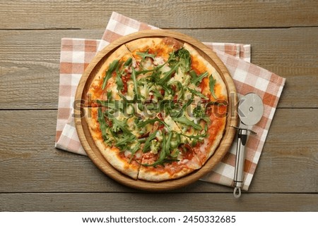 Board with delicious vegetarian pizza on wooden table, top view