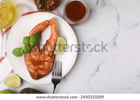 Fresh marinade, cooked fish and other products on white marble table, flat lay. Space for text