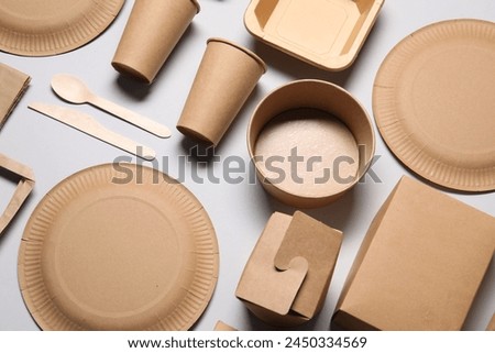 Eco friendly food packaging. Paper containers and tableware on light grey background, above view