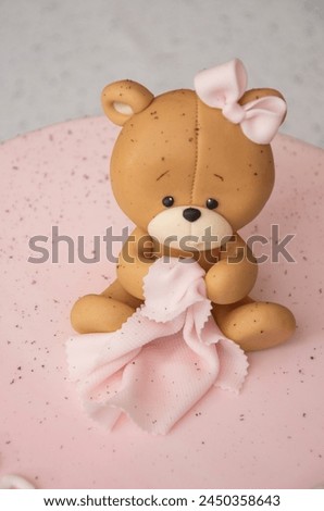 Pink cake decorated with a teddy bear