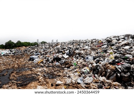 Big pile of trash on a white background Mountains of plastic waste, old rags, and scraps are thrown away on roadsides and public places. Household waste that is difficult to decompose causes pollution Royalty-Free Stock Photo #2450364459