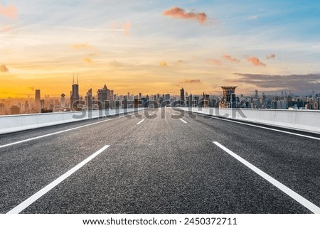Asphalt highway road and city skyline with modern buildings at sunset in Shanghai