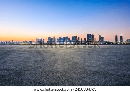 Asphalt road square with modern city buildings at dusk in Hangzhou