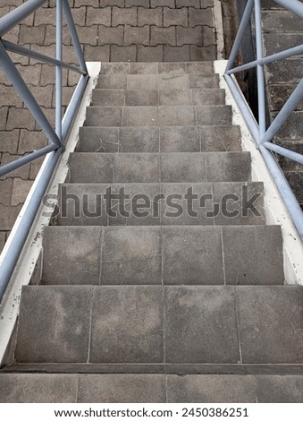 Photo of Stairs from a Top Angle with Blue Ceiling and Cement Steps