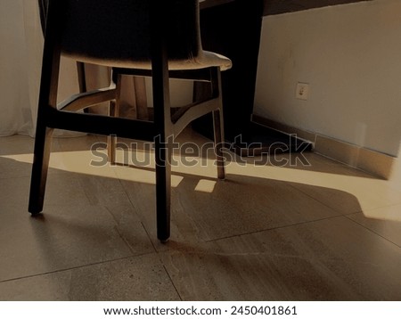 Morning sunlight, yellow, enters the room, through the window, under the chair, next to the bed, as interior background and copy space