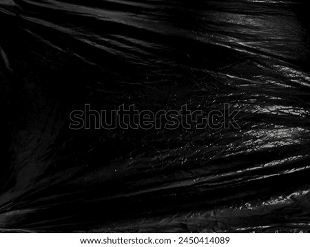 Black transparent plastic wrap texture overlay background. Realistic plastic for poster design and photo overlay effect. Wrinkled plastic surface pattern for graphic design sources and element.