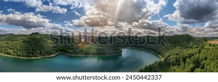 Camera flies over the Hennesee near Meschede and takes a wide view picture. You can see a ship, hills and forests, sunbeams and lens flares. Gorgeous nature in the Sauerland.