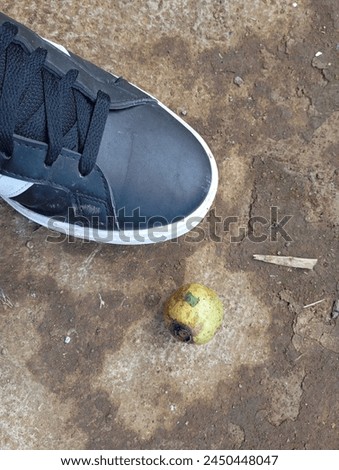 rotten guava next to black shoes