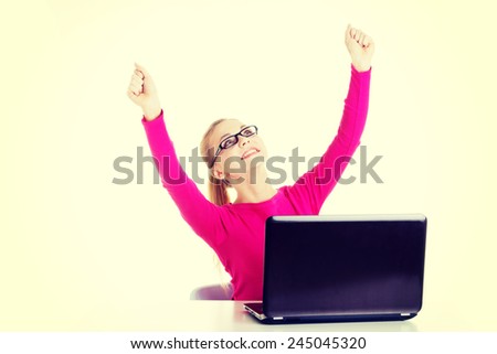 Young happy student woman sitting in front of laptop. 