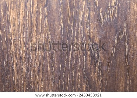 A high-resolution close-up photo of a natural wood grain texture, showcasing its intricate details, variations in color