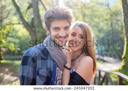 Young couple enjoying in beautiful park at river