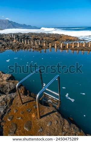 Stairs in the Las Salinas de Agaete natural pools in Puerto de Las Nieves in Gran Canaria, Spain. Royalty-Free Stock Photo #2450475289
