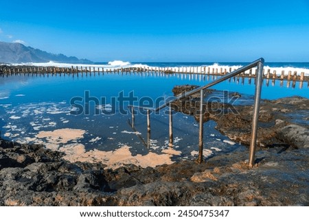 Stairs in the Las Salinas de Agaete natural pools in Puerto de Las Nieves in Gran Canaria, Spain. Royalty-Free Stock Photo #2450475347